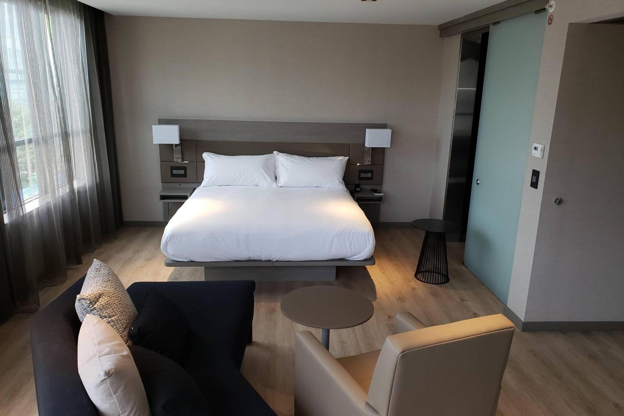 One-Bedroom King Suite Sofa Bed Water View Mobility Accessible Roll Shower